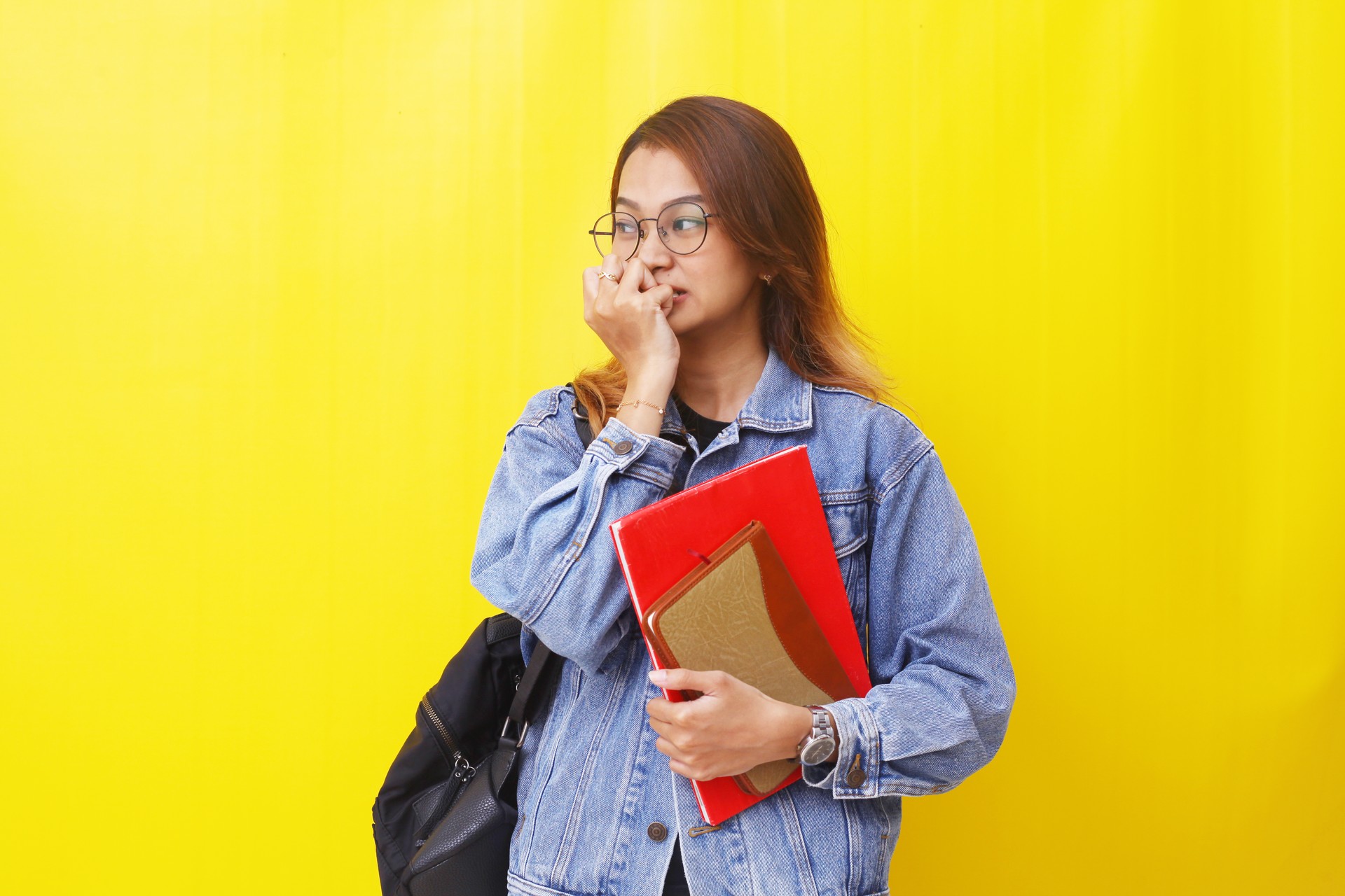 Frightened young asian college student thinking about problems, afraid of difficulties. Isolated