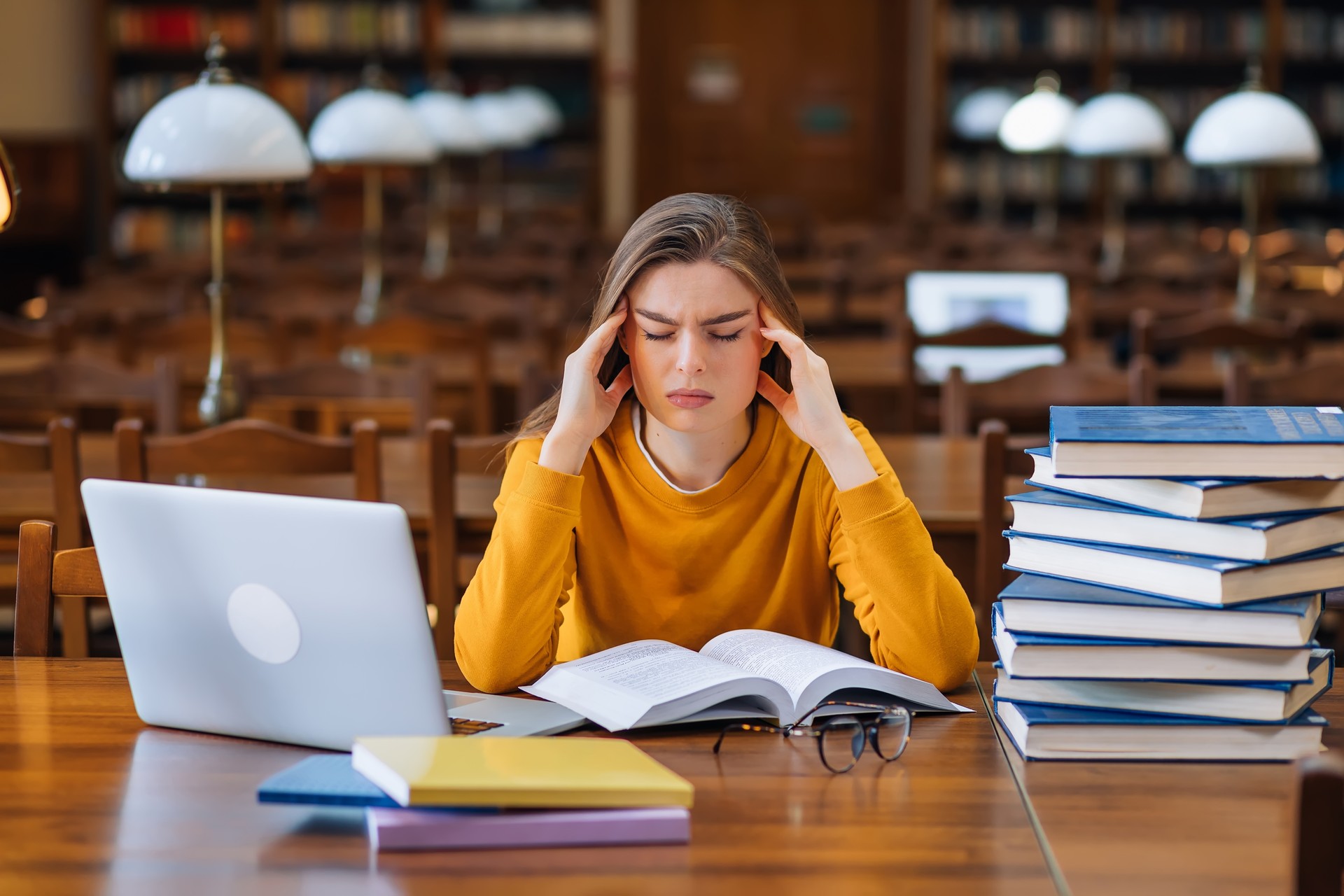 female student preparing for an exam, touching neck with hands,